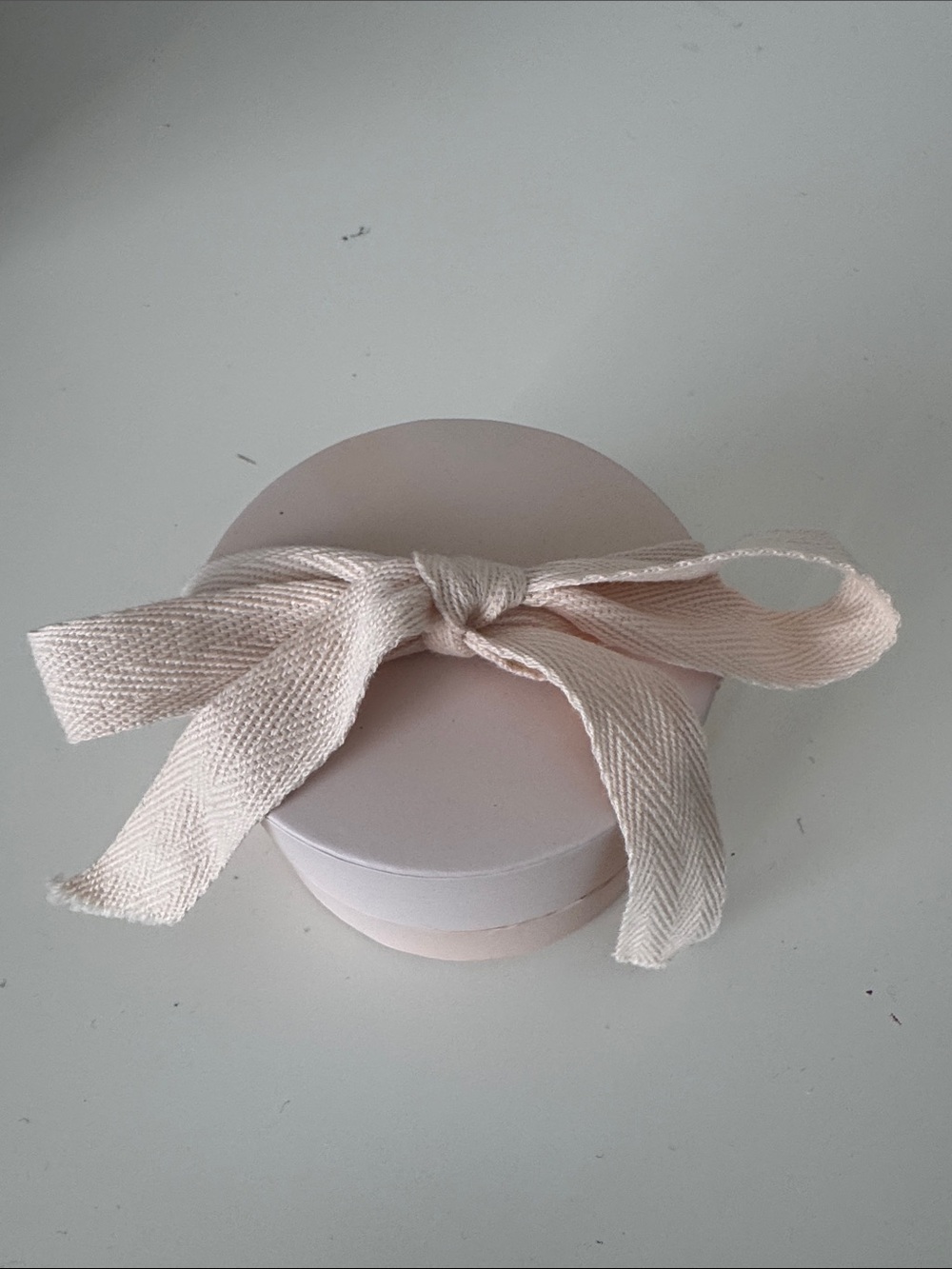 gorjana blush jewelry gift box featuring a textured cream fabric and jewlery bag